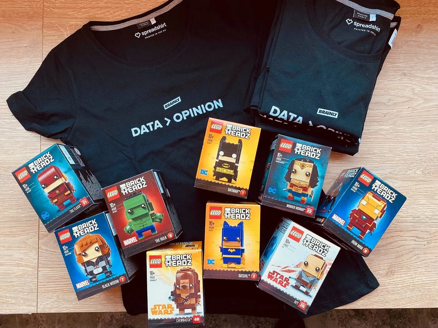 A few sets of Lego BrickHeadz presented on a Tshirt with “DATA > OPINION”