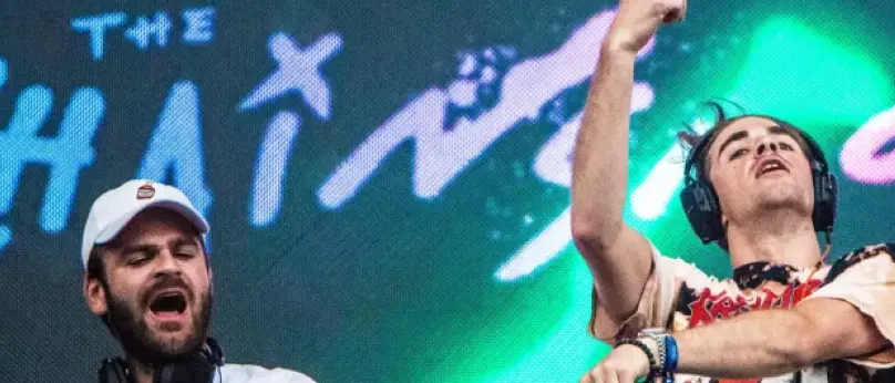 The Chainsmokers performing on a rooftop.