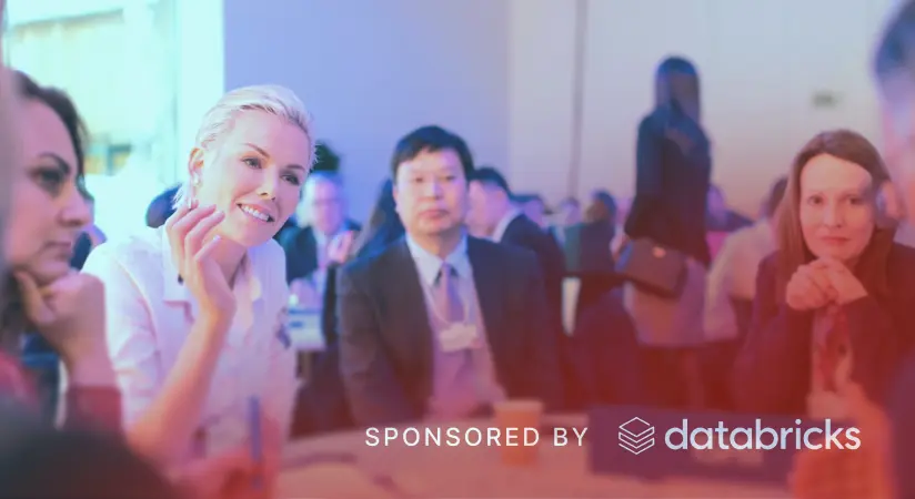 Industry leaders raising glasses at a curated lunch, sponsored by Databricks.