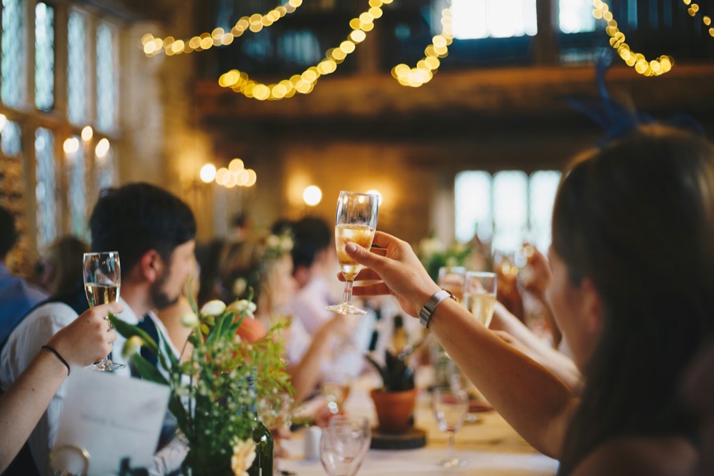 Industry leaders raising glasses at a curated lunch.